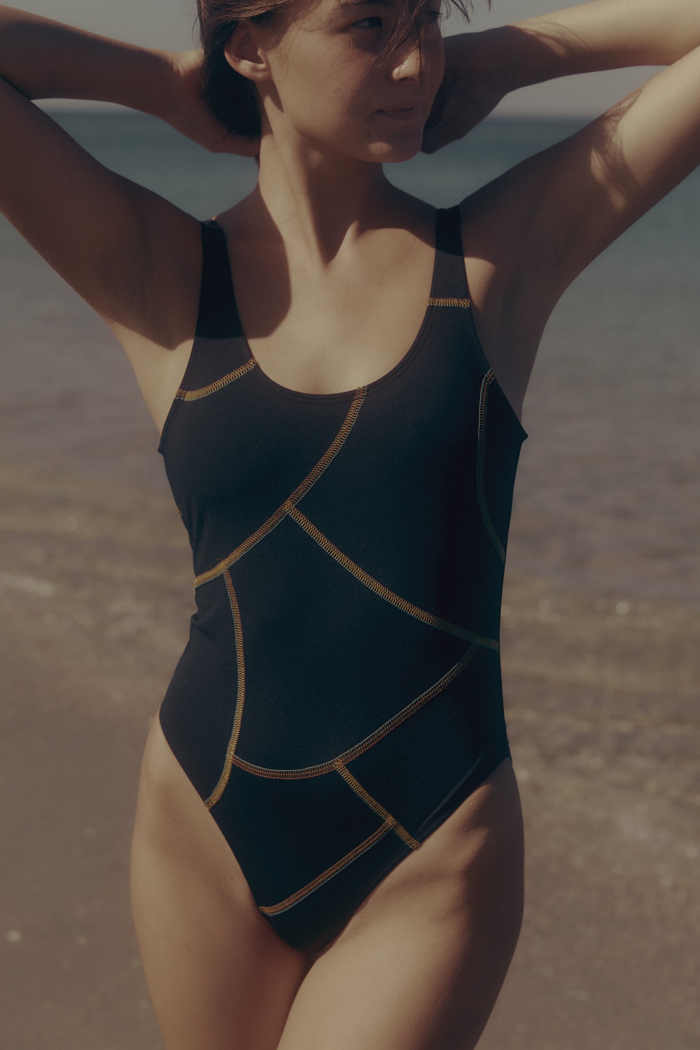 Black one-piece swimsuit with contrast multi stitch detail by Luka Rey. 